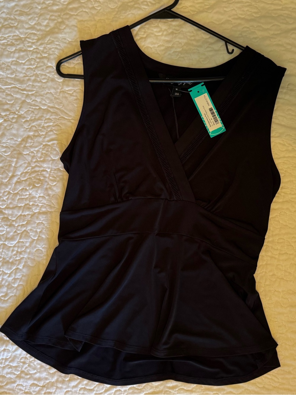 Sleeveless V-Neck Peplum Top in Black